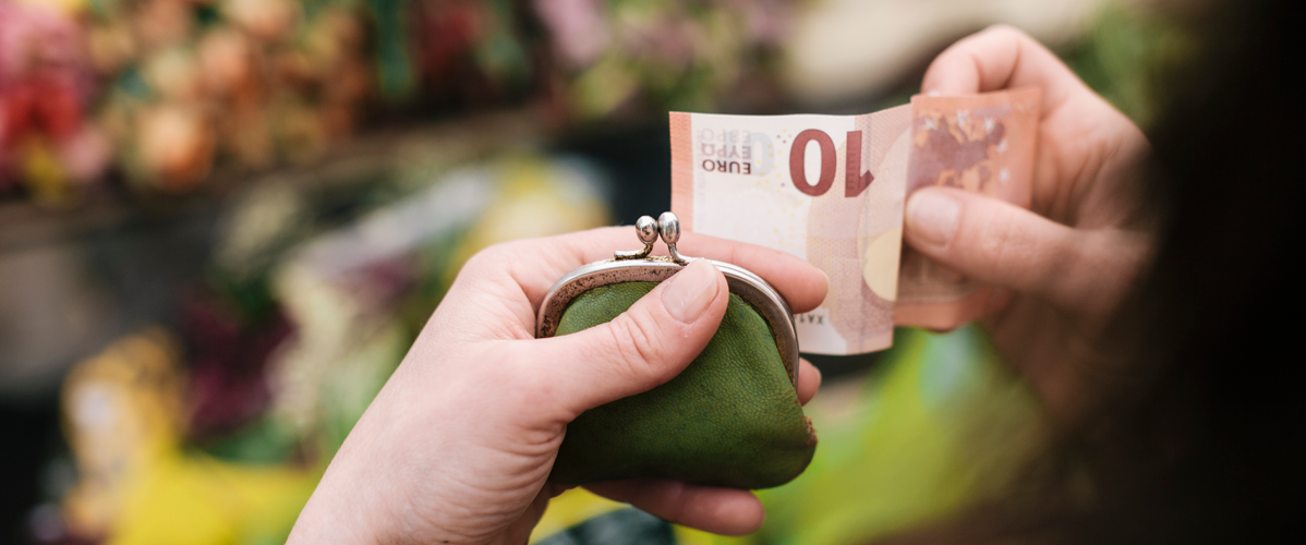 A person handles a ten euro banknote