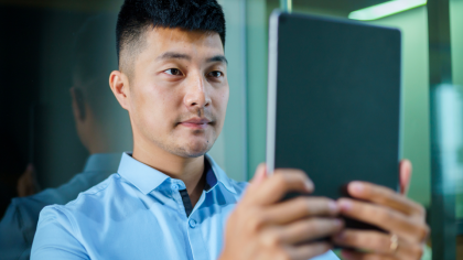 A man having his face scanned by a tablet for better audiovisual recognition